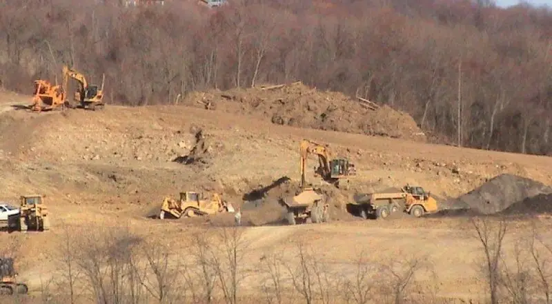 Dozers, loaders and an excavator working a cut on a Shallenberger site