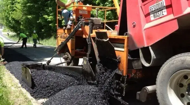 A Shallenberger paving crew working behind the paver on a road job