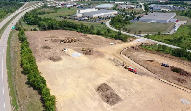 Aerial of a cleared Shallenberger site beside the highway and an industrial park